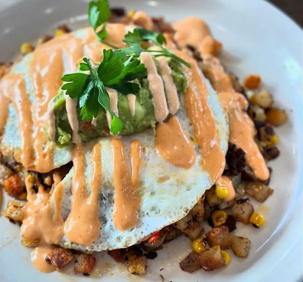 Fried egg with chipotle aioli over chorizo and guac